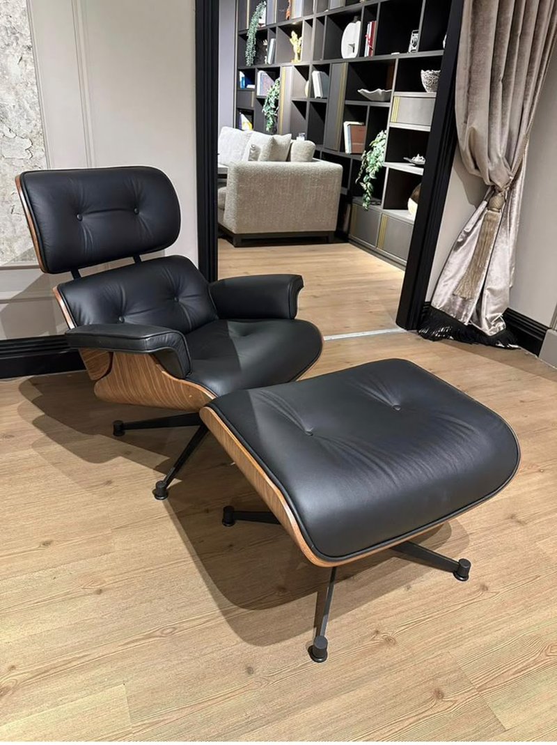 black leather lounge chair with matching ottoman and wooden side panels - Image 1